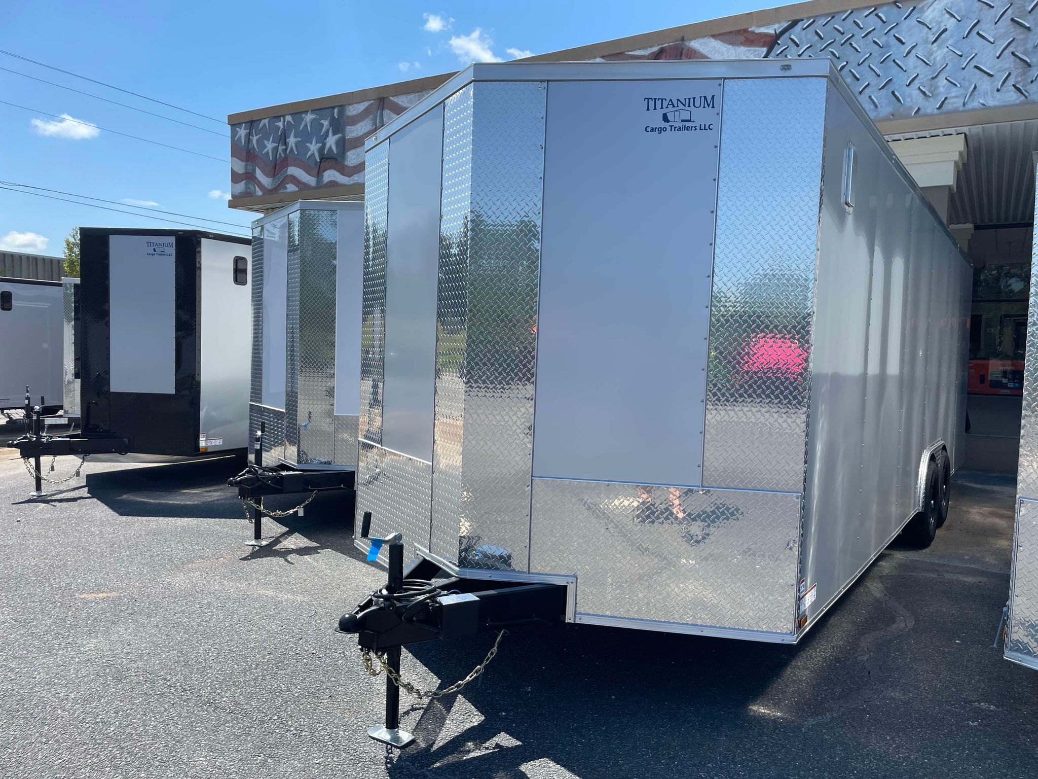 Titanium Cargo 8.5x24 enclosed cargo trailer with Silver Frost polycore exterior, tandem axles, 7-foot interior height, and heavy-duty ramp door for sale.