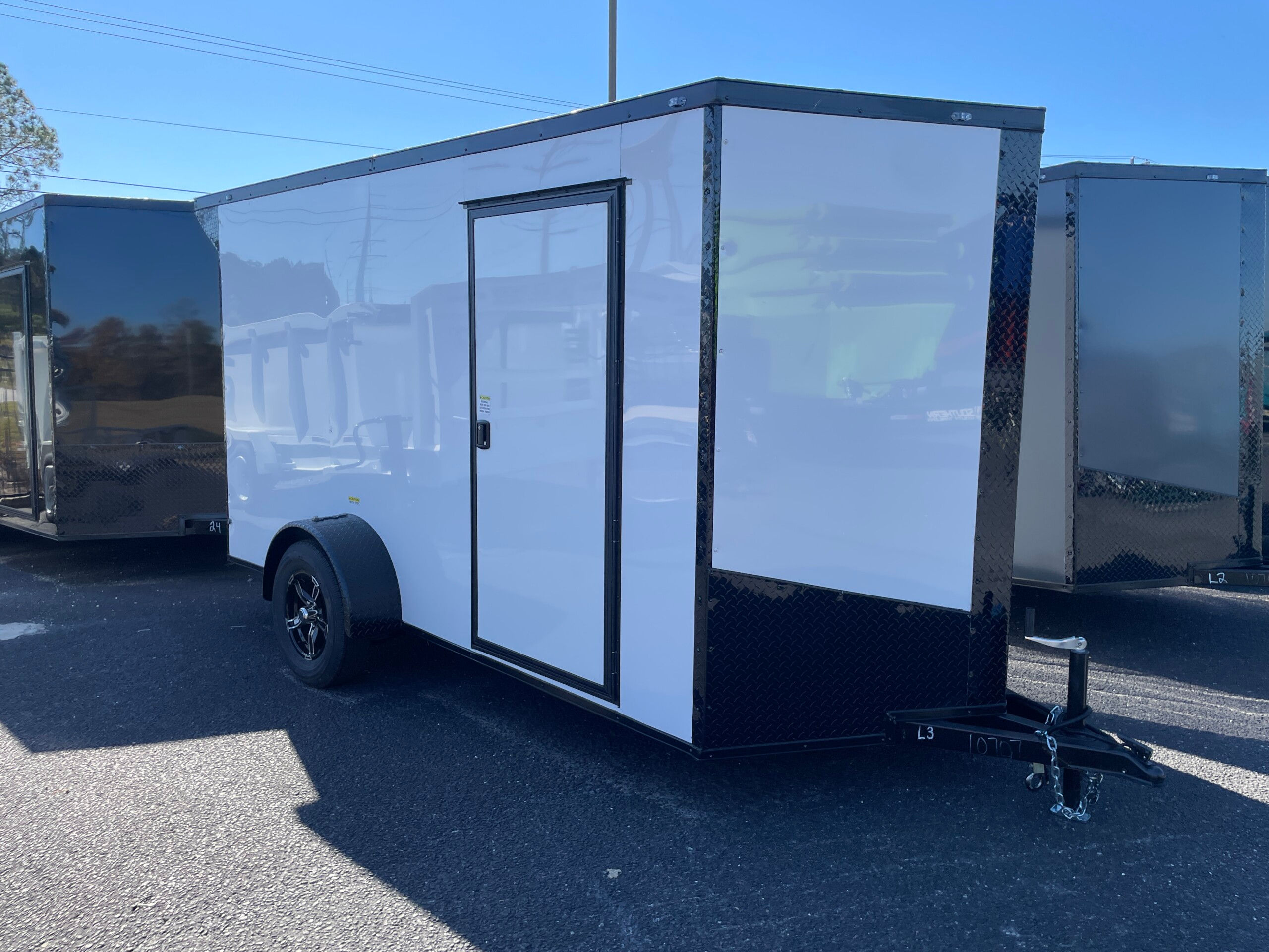 White Blackout Deep South 6x12 single axle enclosed cargo trailer with Polycore exterior alloy wheels and spoiler LED lights