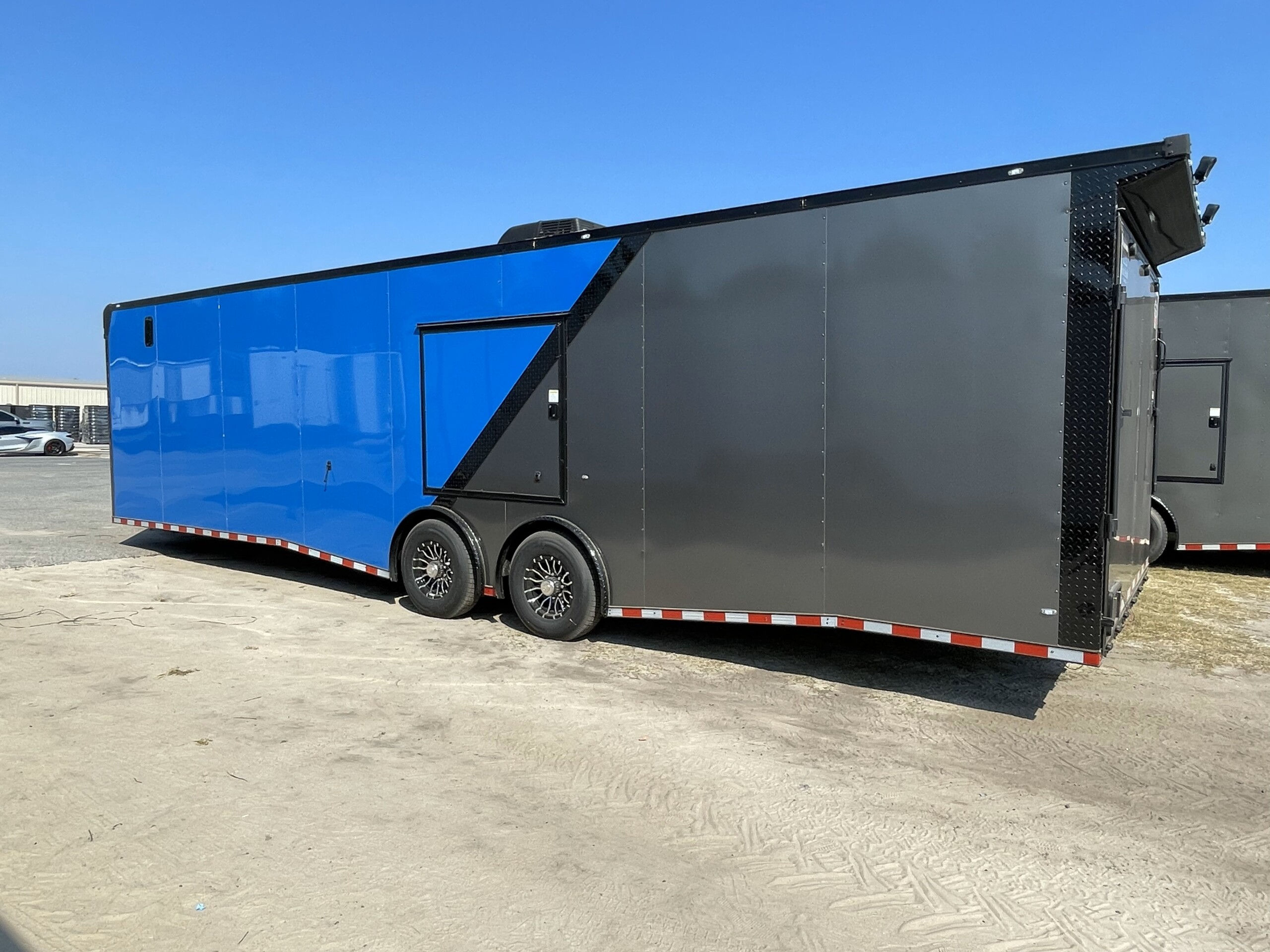Rock Solid Cargo 8.5x32 enclosed race car trailer with two-tone polycore exterior, race package, cabinets, A/C, E-track flooring, and blackout package.