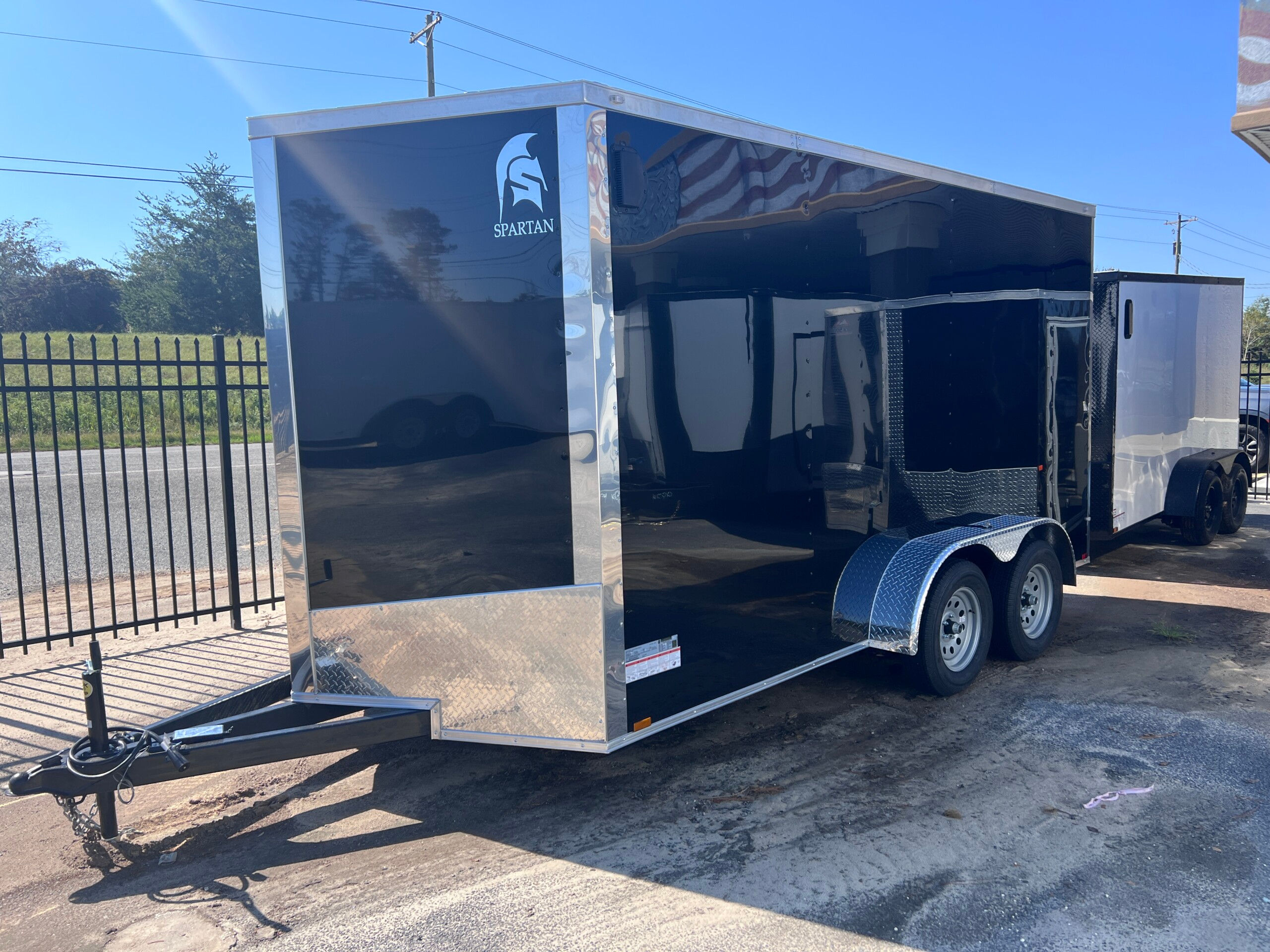 Spartan Cargo 7x14 black enclosed cargo trailer with polycore exterior, semi-screwless design, extended triple tube tongue, and 7-foot interior for sale.