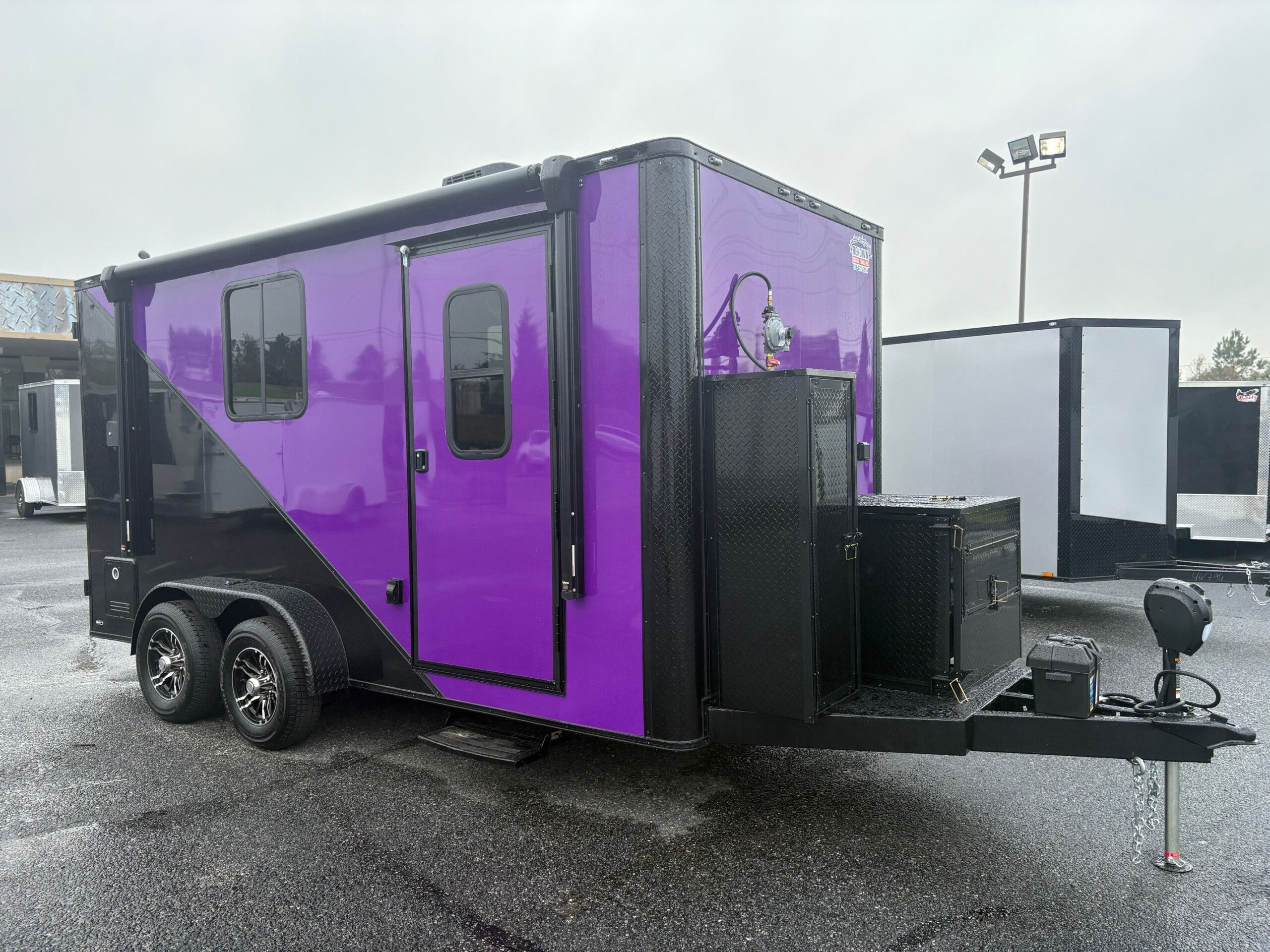 Legacy Series 7x16 purple and black pet grooming trailer with generator, electric grooming table, Flying Pig tub, awning, and SDG Premier Package for sale.