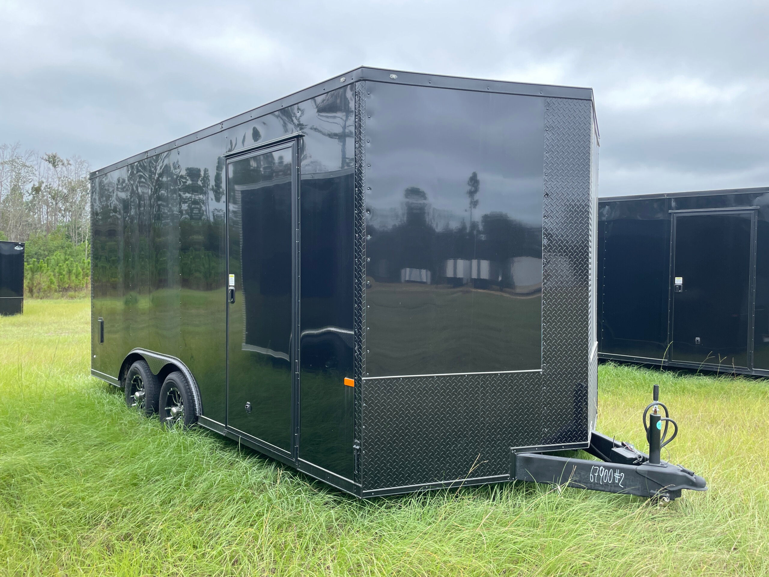 8.5x16 tandem axle enclosed cargo trailer with .080 Polycore exterior, blackout package, alloy wheels, and 7-foot interior height