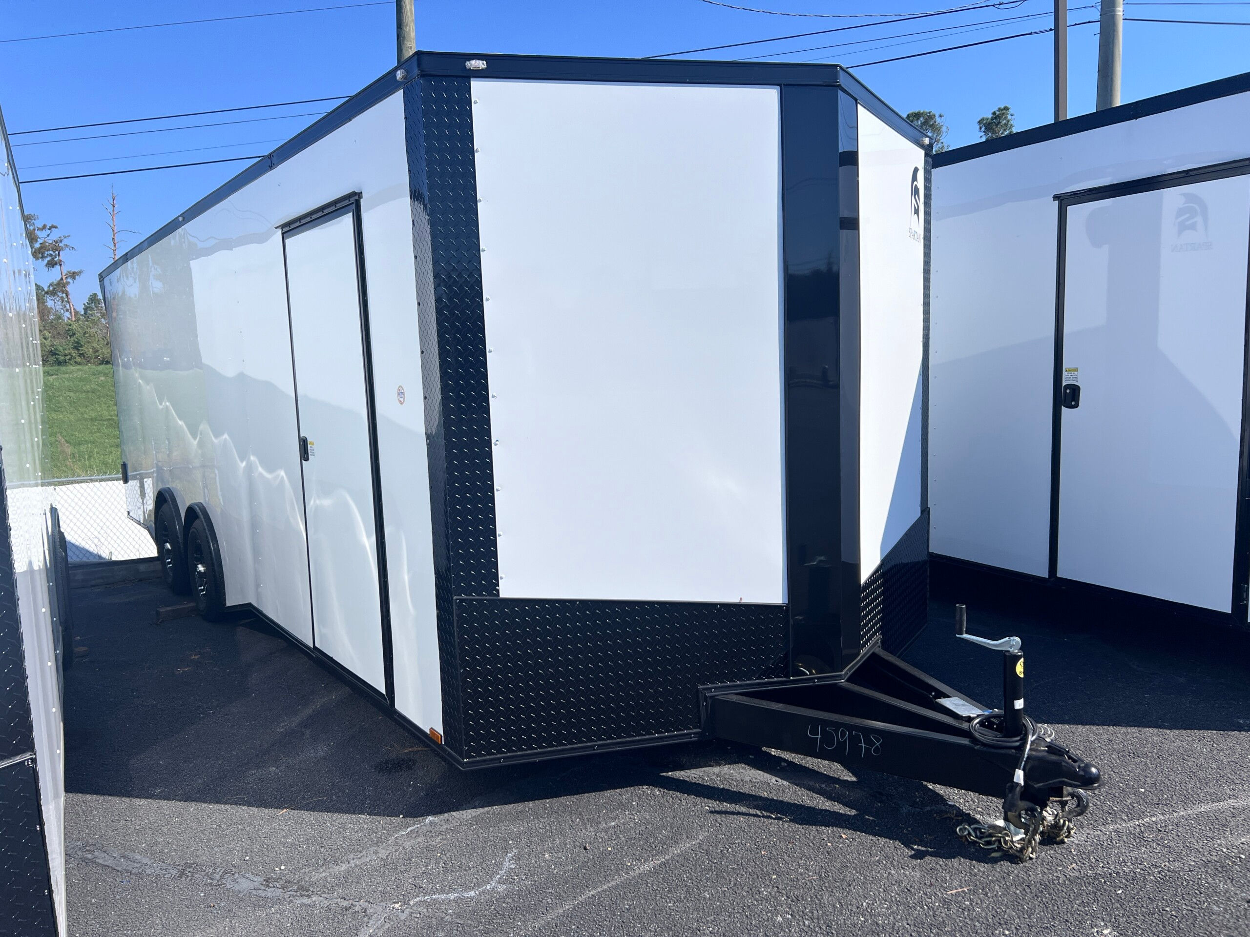 Spartan Cargo 8.5x24 enclosed cargo trailer with polycore exterior, blackout package, spread torsion axles, spoiler with lights, and 7-foot interior for sale.