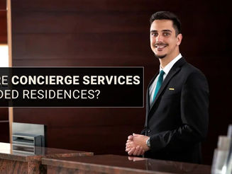 Concierge staff assisting residents at luxury branded residence reception desk