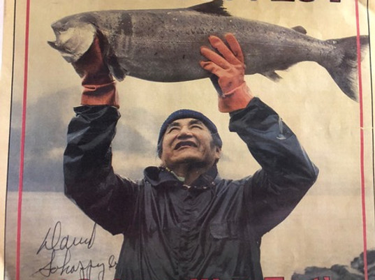 man holding fish overhead