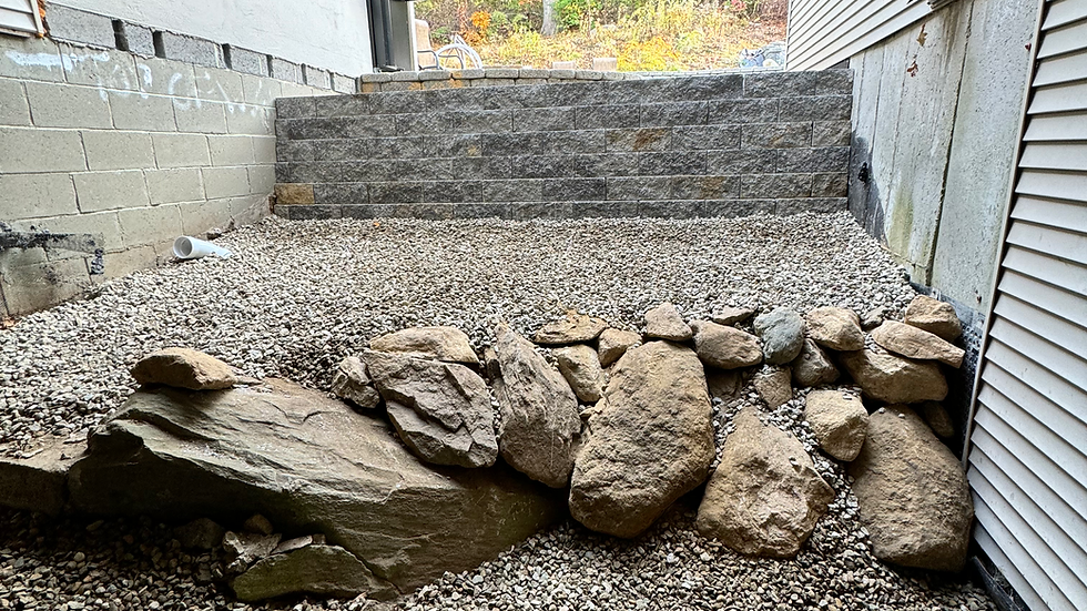 Stairs and gravel create a foundational drainage for a Cape Cod Home