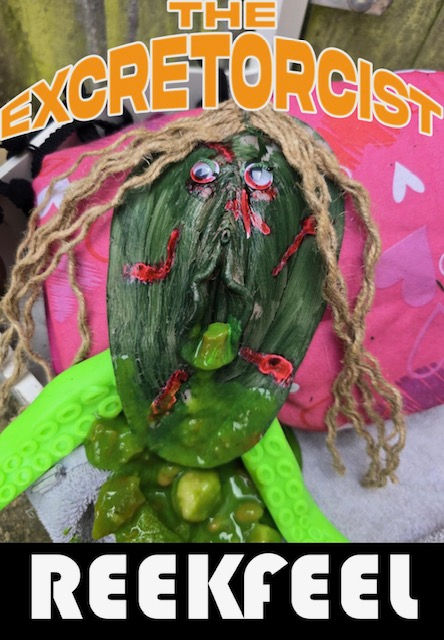 Grotesque cover showing a green, distorted face with yarn hair, googly eyes, and red wounds, vomiting thick green slime.