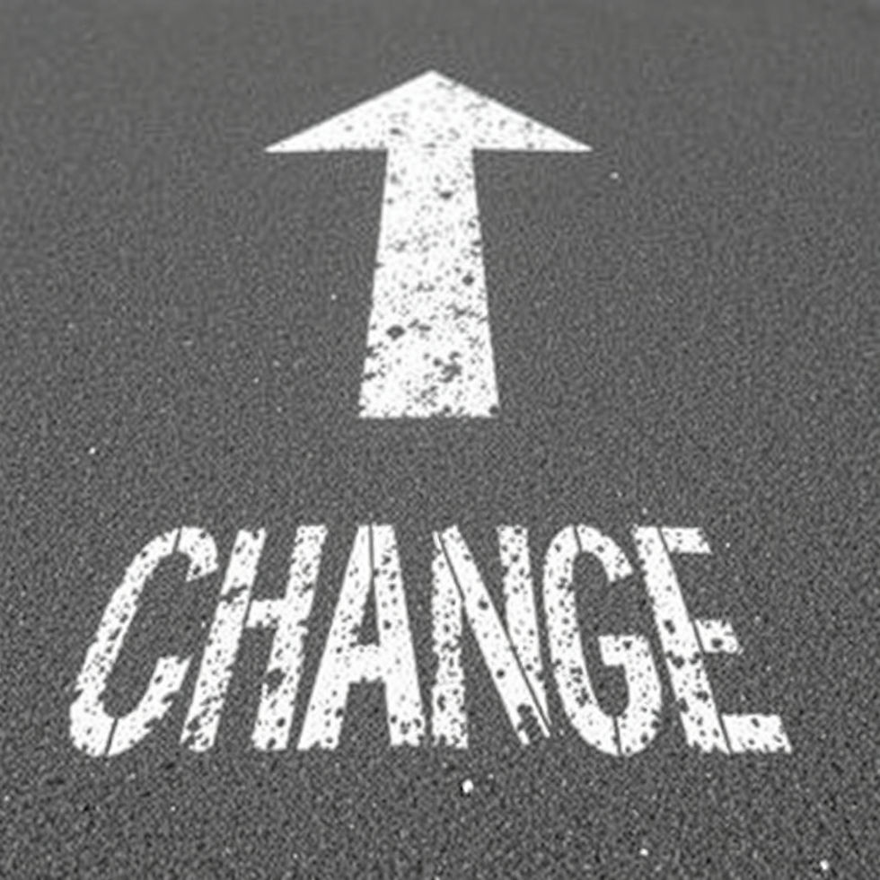 a solid white painted arrow on pavement with the word change in front of it