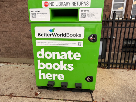 Large green container where people to donate books.