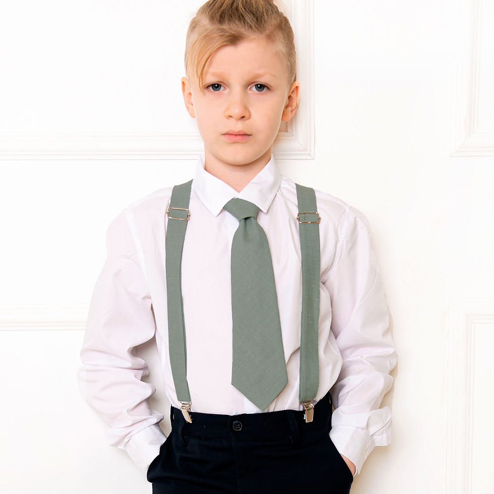 A boy with a dark sage green tie set white background indoor