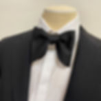 Close-up of black satin self-tie bow tie