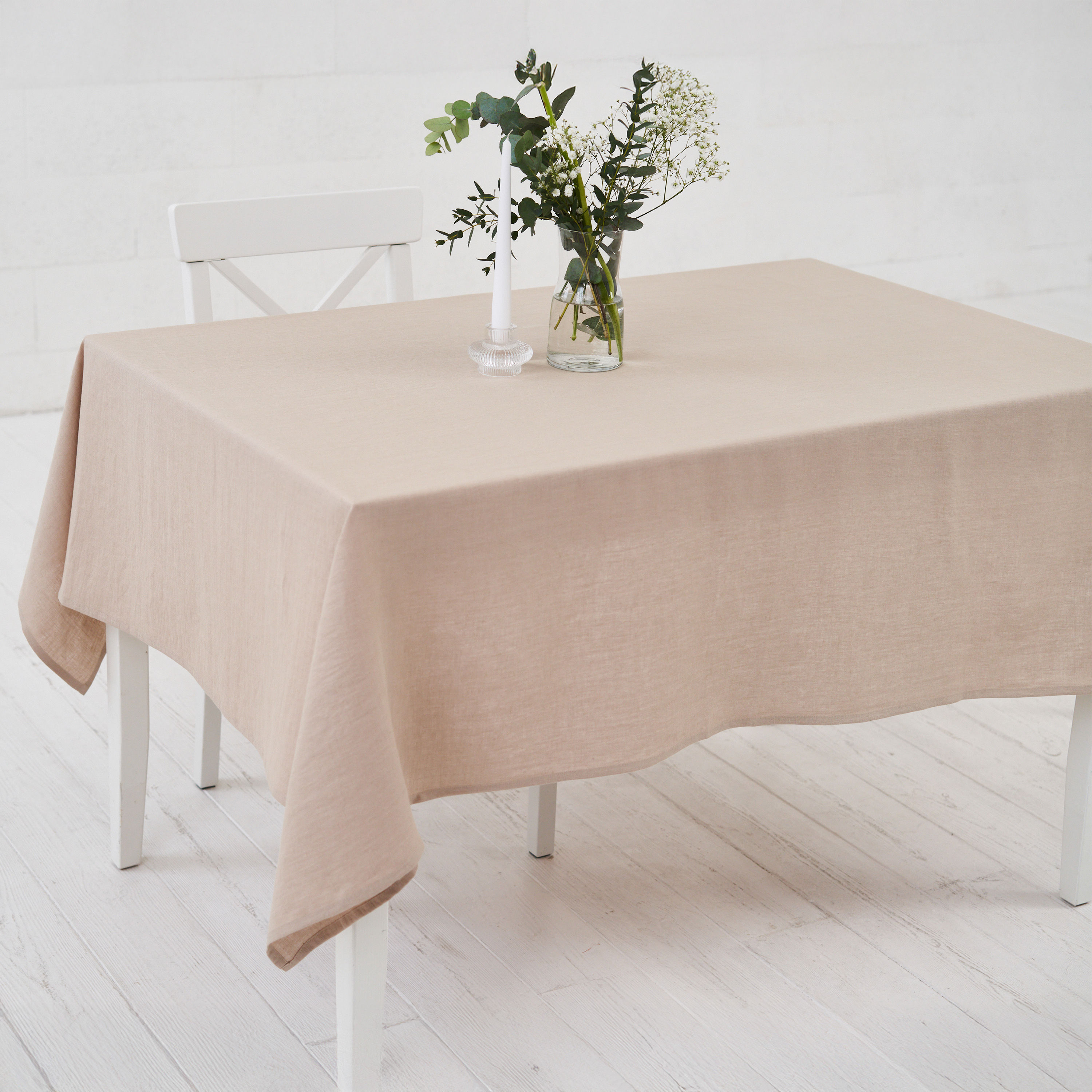 Beige linen tablecloth on a minimalist dining table