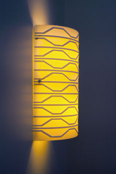 Yellow patterned feature wall with decorative lighting