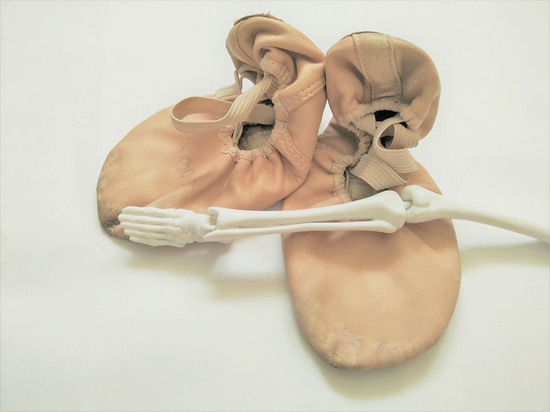 ballet shoes and model skeleton of leg