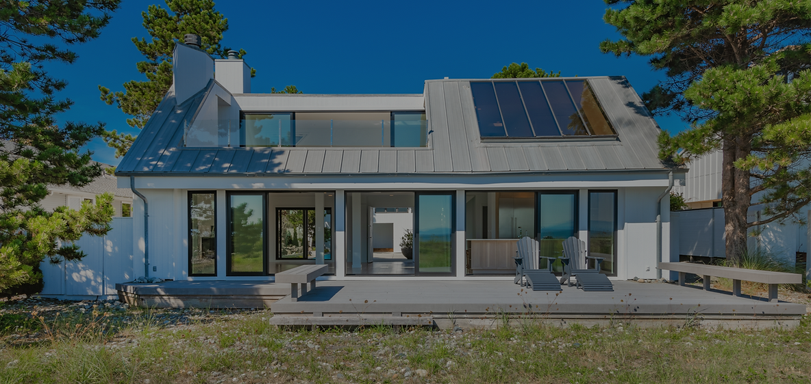 Exterior view of a modern contemporary house home building surrounded by large pine trees