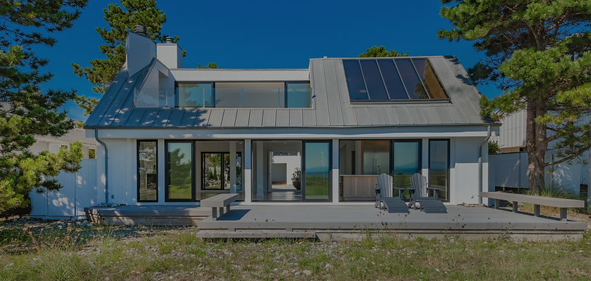 Exterior view of a modern contemporary house home building surrounded by large pine trees