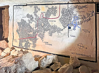 During our trip to Maastricht, Diane's curiosity led us to explore the depths of the Maastricht Underground. These ancient limestone caves, initially carved out by Romans, served as the city's foundation for centuries. Although once valued for their high-quality limestone, they later became a popular tourist attraction. On our guided tour, we were led by a charismatic local through the underground maze, which extended into Belgium. Our path was dimly lit, and the walls were decorated with charcoal drawings, some of which dated back to the 1700s, giving the place an eerie charm. Our guide warned us not to stray too far as the tunnels were extensive, and the consequences could be severe.