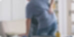 Image of a person holding their lower back in pain.