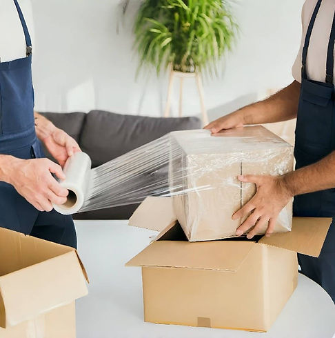 People wrapping a cardboard box with clear biodegradable stretch film for eco-conscious shipping.
