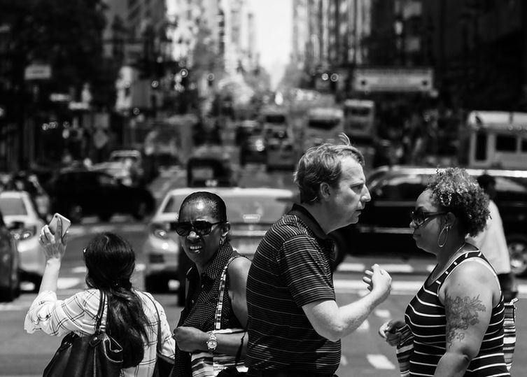 NYC hustle: A snapshot of people crossing the road in the bustling energy of New York City's streets