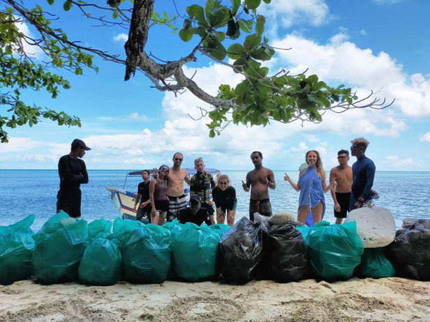 Volunteers with bags of trash for marine conservation Langkawi.