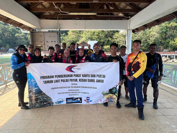 Marine conservation Langkawi team with cleanup banner.