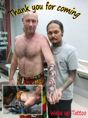 Tribal dragon tattoo by Wake up Tattoo Phuket