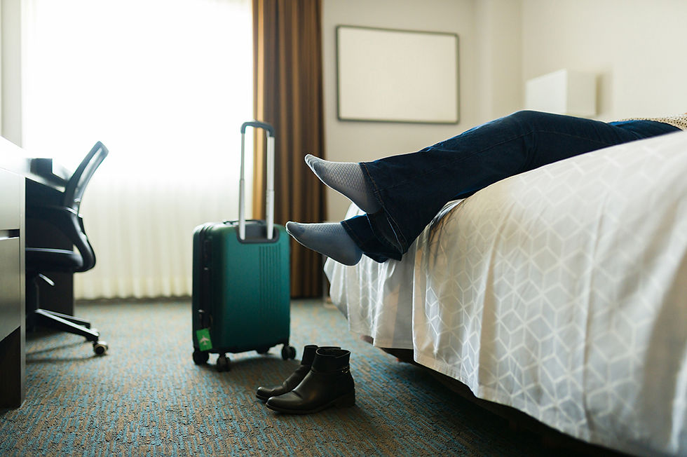 A woman collapsed on her hotel bed after a long-haul flight. Photographer: Antonio Diaz | iStock.