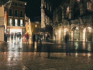 A town square at night with blurred people moving around