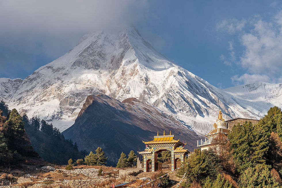 A Tibetan monastery and the Manaslu mountain peak, the eighth highest peak in the world, Nepal. Photographer: Skazzjy | iStock.