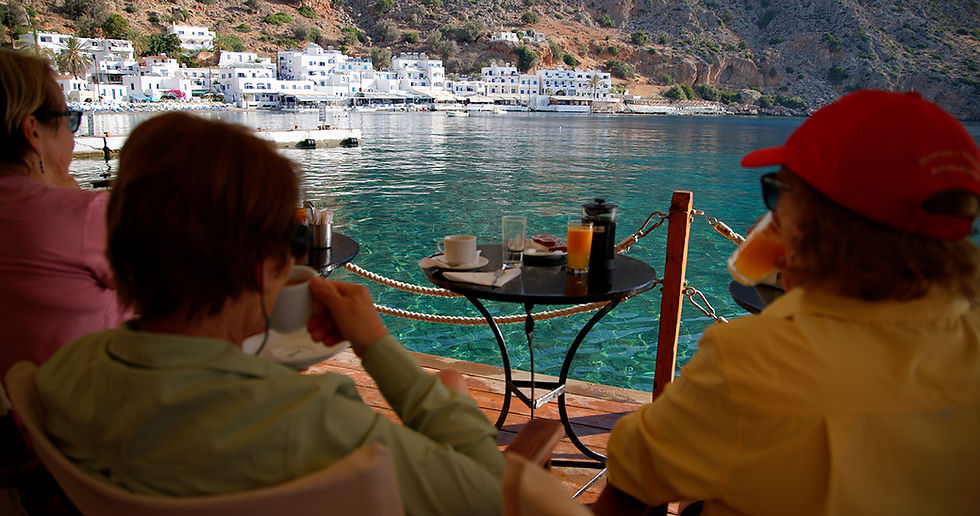 Newfound friends relaxing over a morning coffee before beginning our hike exploring Loutro