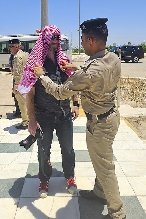David having his Keffiyeh adjusted by a helpful soldier in Iraq