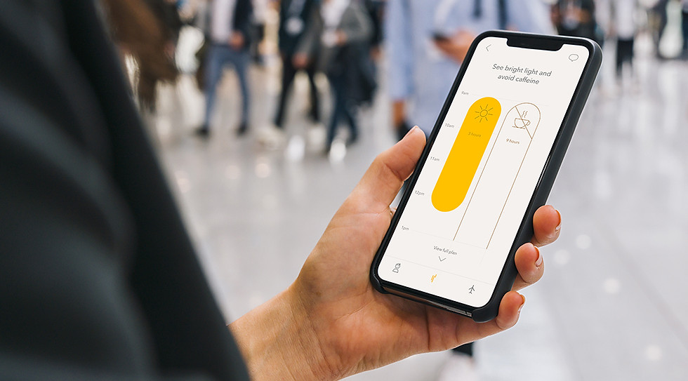 A woman looking at the Timeshifter app screen on her phone in airport