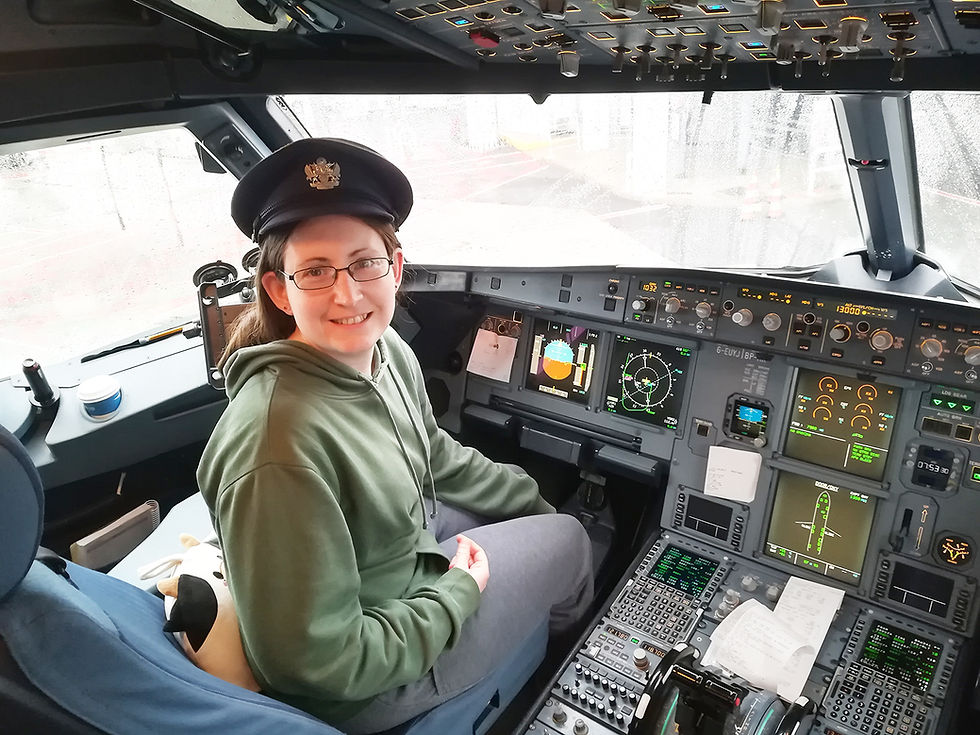 Louisa poses for a photograph in the cockpit of an aircraft