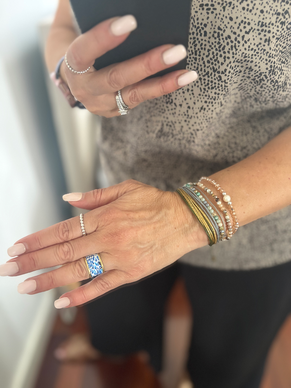 Thumbnail: Hand with layered bracelets and rings
