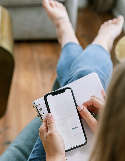 mom laying on sofa checking phone