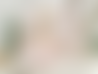 Two people resting in a calm indoor space with plants, with a Human Design bodygraph overlay