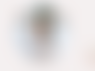 Girl sitting on a bed in a calm quiet space — illustrating the Human Design Reflector child's need for rest and solitude