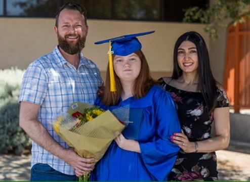 Kinzie at graduation with her parents