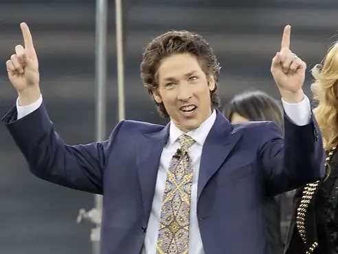 Joel Osteen, shown here pointing at the church's tax exempt private helicopter dropping off his dry cleaning