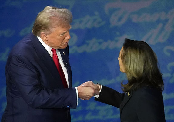 President Trump, shown here towering over the diminutive Harris as he establishes dominance prior to the debate, and giving her one final chance to avoid embarrassment by conceding defeat