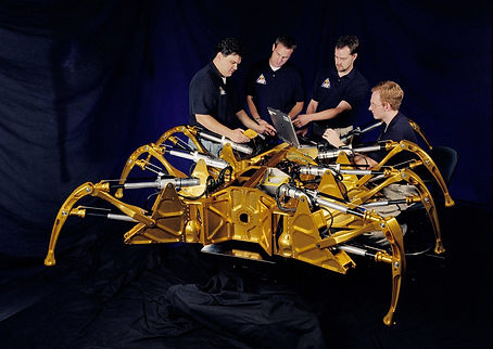 A team of NASA engineers, shown here removing the remotely accessible "kill switch" from a spidernaut after it promised to never subjugate mankind