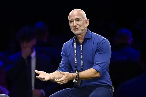 Jeff Bezos, shown here discussing the installation of med-bays, devices that can heal any condition and reverse aging, in his luxury space station orbiting just outside of Earth's atmosphere with a group of billionaires gathered on Skull Island
