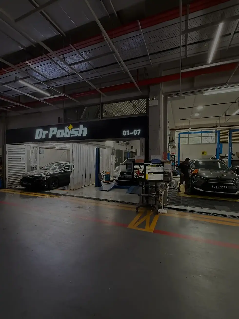 Dr Polish Singapore workshop at AMK AutoPoint showing car grooming area with vehicles receiving detailing and polishing services