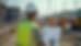 Eye-level view of a construction site with a Site Supervisor reviewing plans