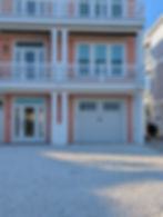 White garage door install on a peach house.