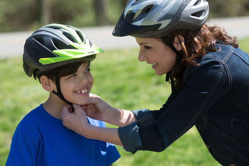 mom putting helmet on son.jpg