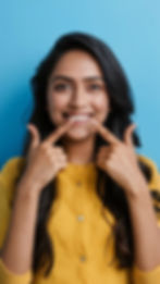 young-indian-woman-isolated-blue-background-smiles-pointing-fingers-mouth.jpg