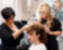 Stylists styling a client's curly hair at the best salon.