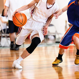 High-school-student-dribbling-past-a-defender.jpeg